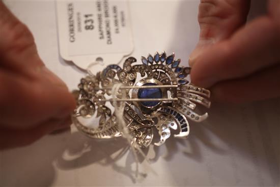 A modern ornate white gold and platinum, sapphire and diamond set clip brooch, 64mm.